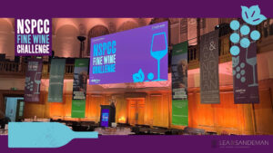 The NSPCC fine wine challenge room showing the banners of the NSPCC and various sponsers.