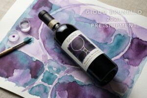 A bottle of the Giodo Brunello Di montalcino resting on a purple abstract watercolour.